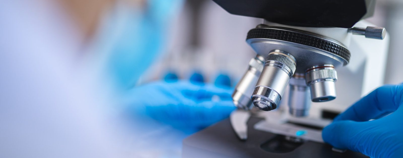 Medical Practice Web Design Laboratory microscope with a researcher in blue gloves